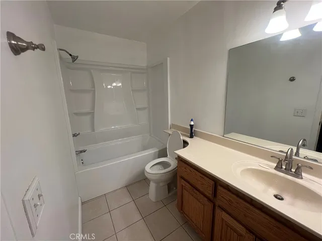 a bathroom with a sink a toilet a mirror and shower