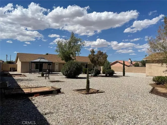 a view of a yard with cars