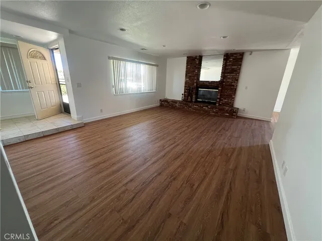 wooden floor in an empty room with a mirror