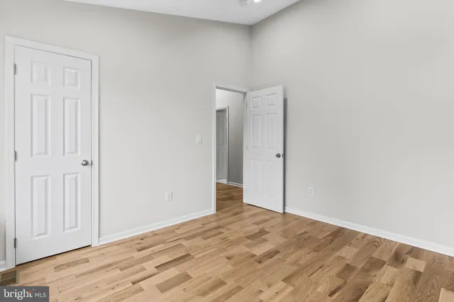 an empty room with wooden floor