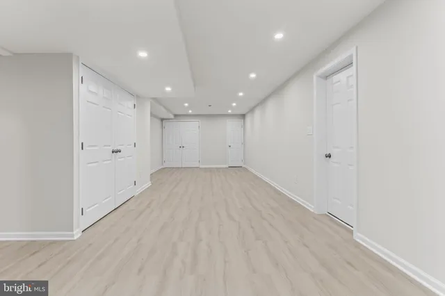wooden floor in an empty room with a kitchen