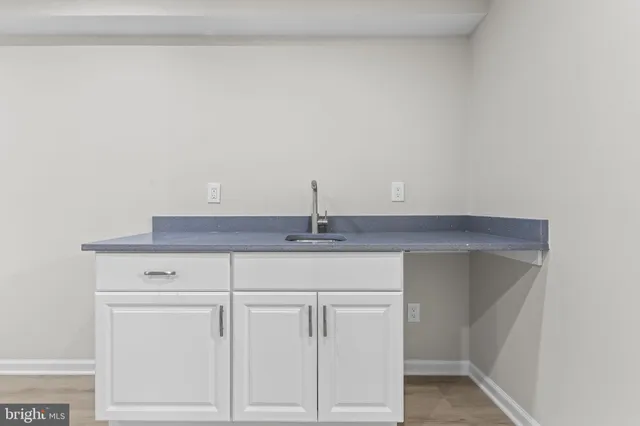 a view of house with yard and trees in the background