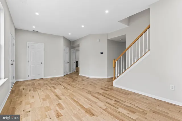 a view of hallway with wooden floor