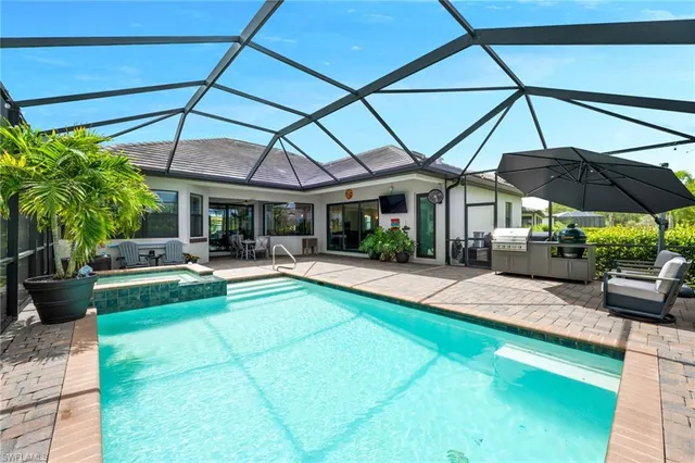 a view of patio with chairs and table under an umbrella