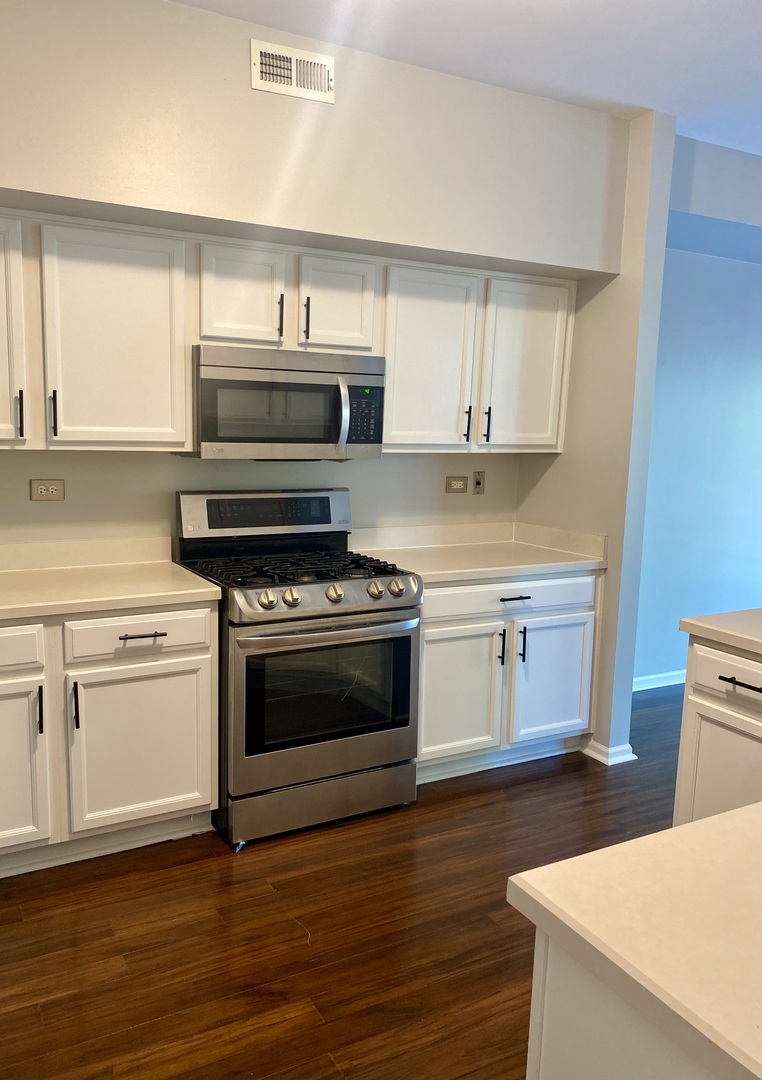 2402 Georgetown Circle Aurora, IL 60503 - Photo 4 of 10 a kitchen with a stove and a microwave