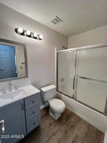 a bathroom with a toilet a sink and a mirror