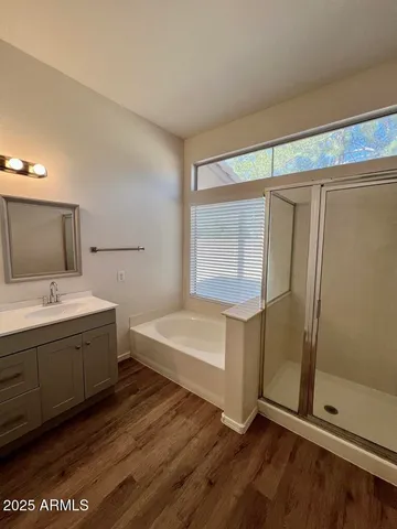 a bathroom with a tub sink and mirror