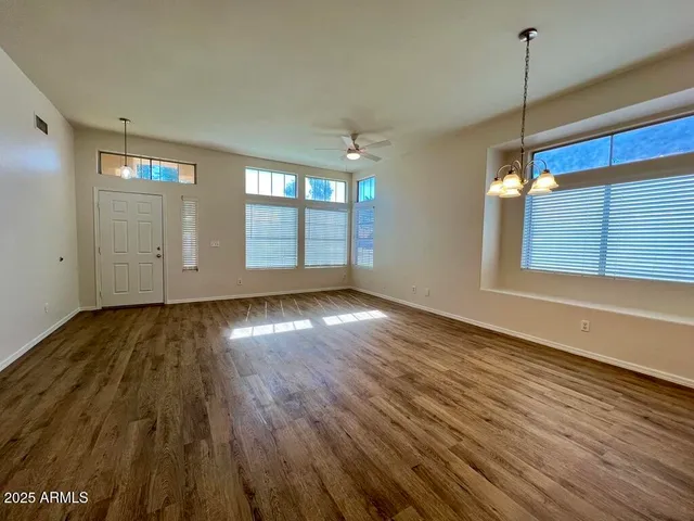 a view of a room with wooden floor and window