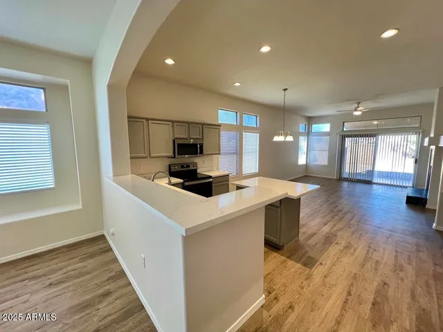 a kitchen with a sink a counter top space stainless steel appliances and a window