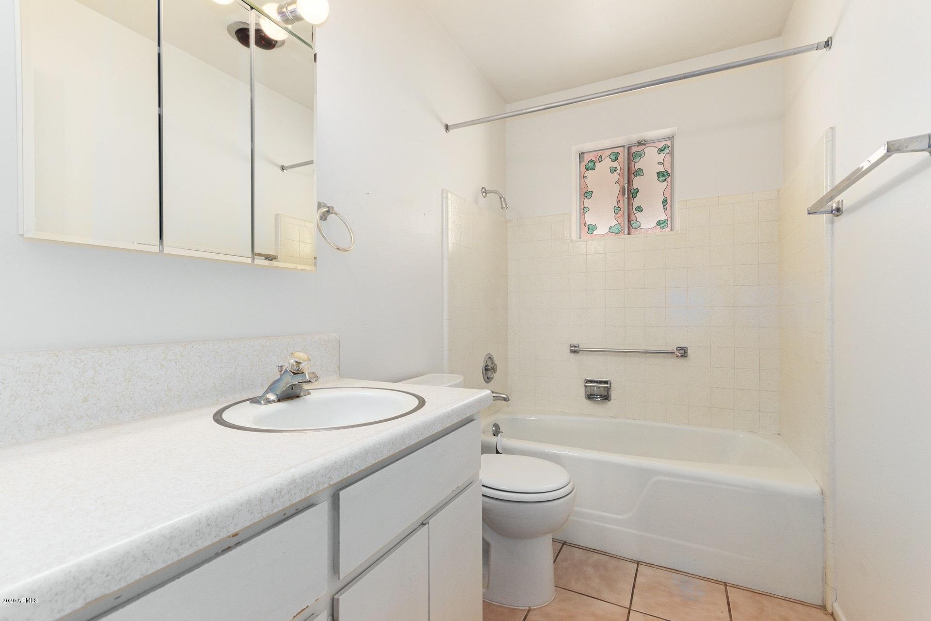 5704 East Decatur Street Mesa, AZ 85205 - Photo 26 of 40 a bathroom with a sink a toilet and shower