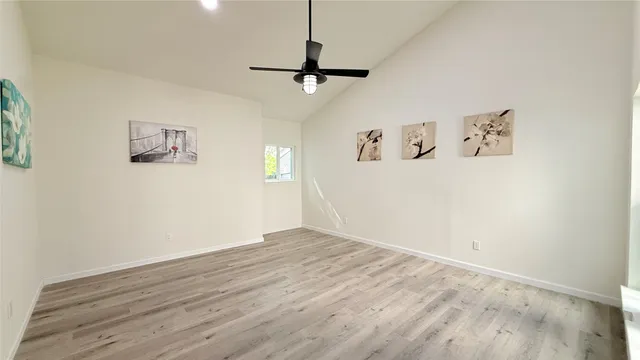 a view of a hallway with wooden floor and entryway