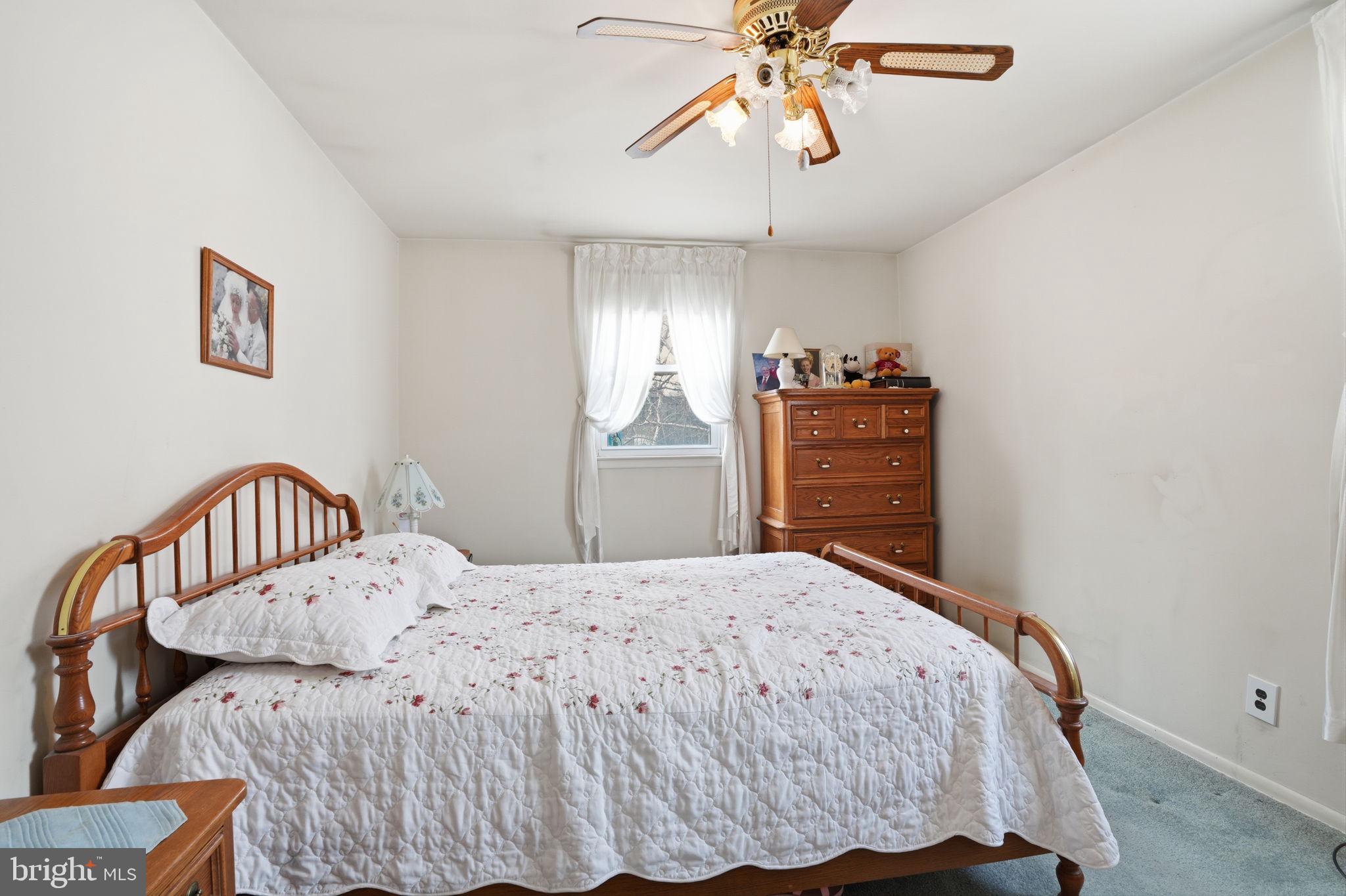3622 Chesterfield Road Philadelphia, PA 19114 - Photo 10 of 23 a bedroom with a bed and a chandelier