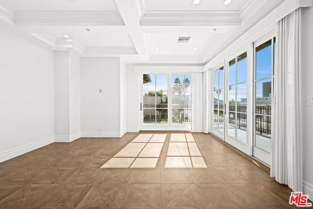 a large white kitchen with kitchen island a stove a sink dishwasher and a refrigerator with wooden floor