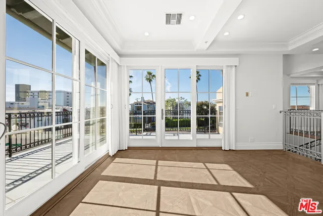 a large white kitchen with kitchen island a sink a stove a refrigerator and a dining table