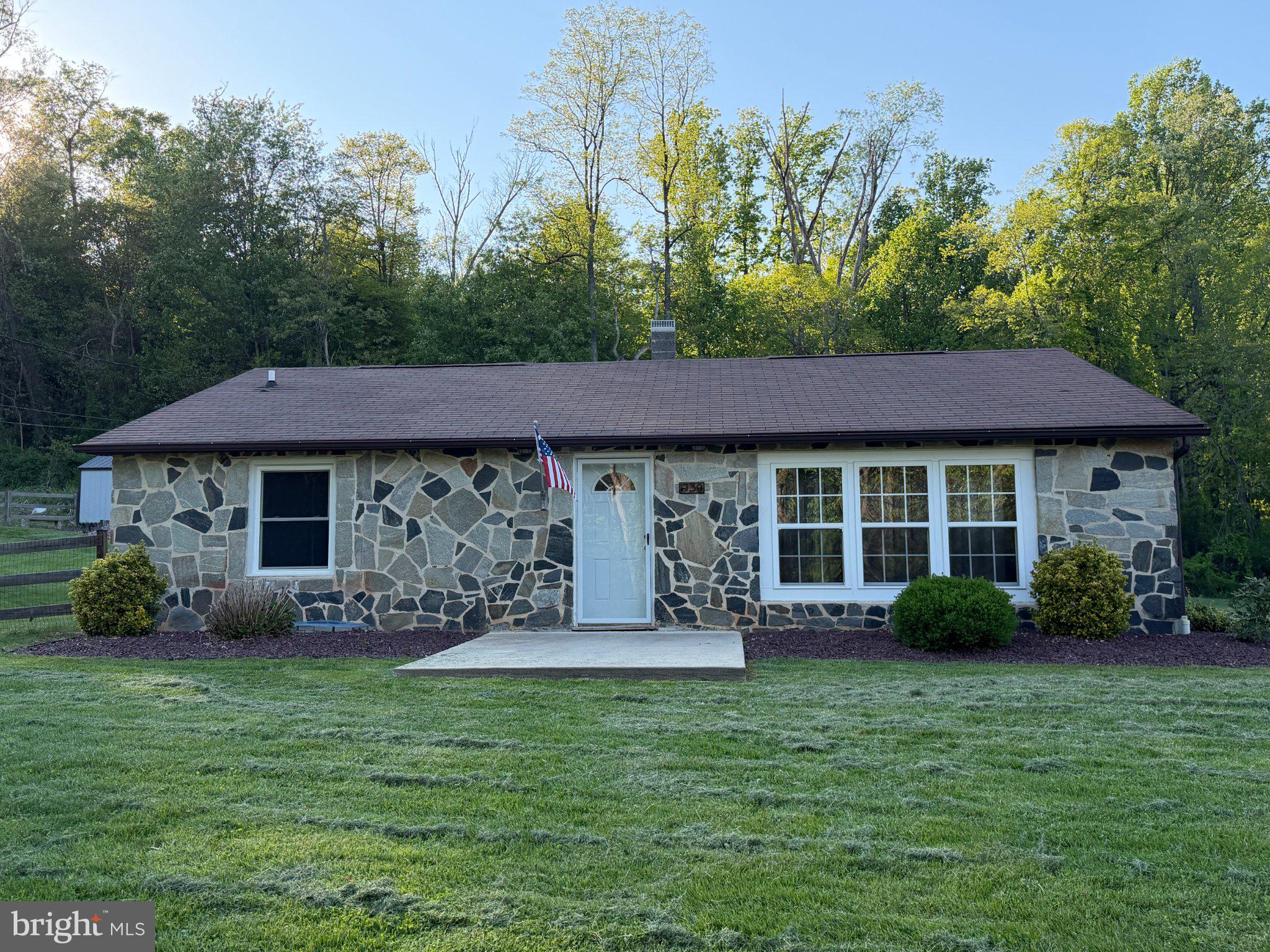 Charming stone cottage in serene setting.