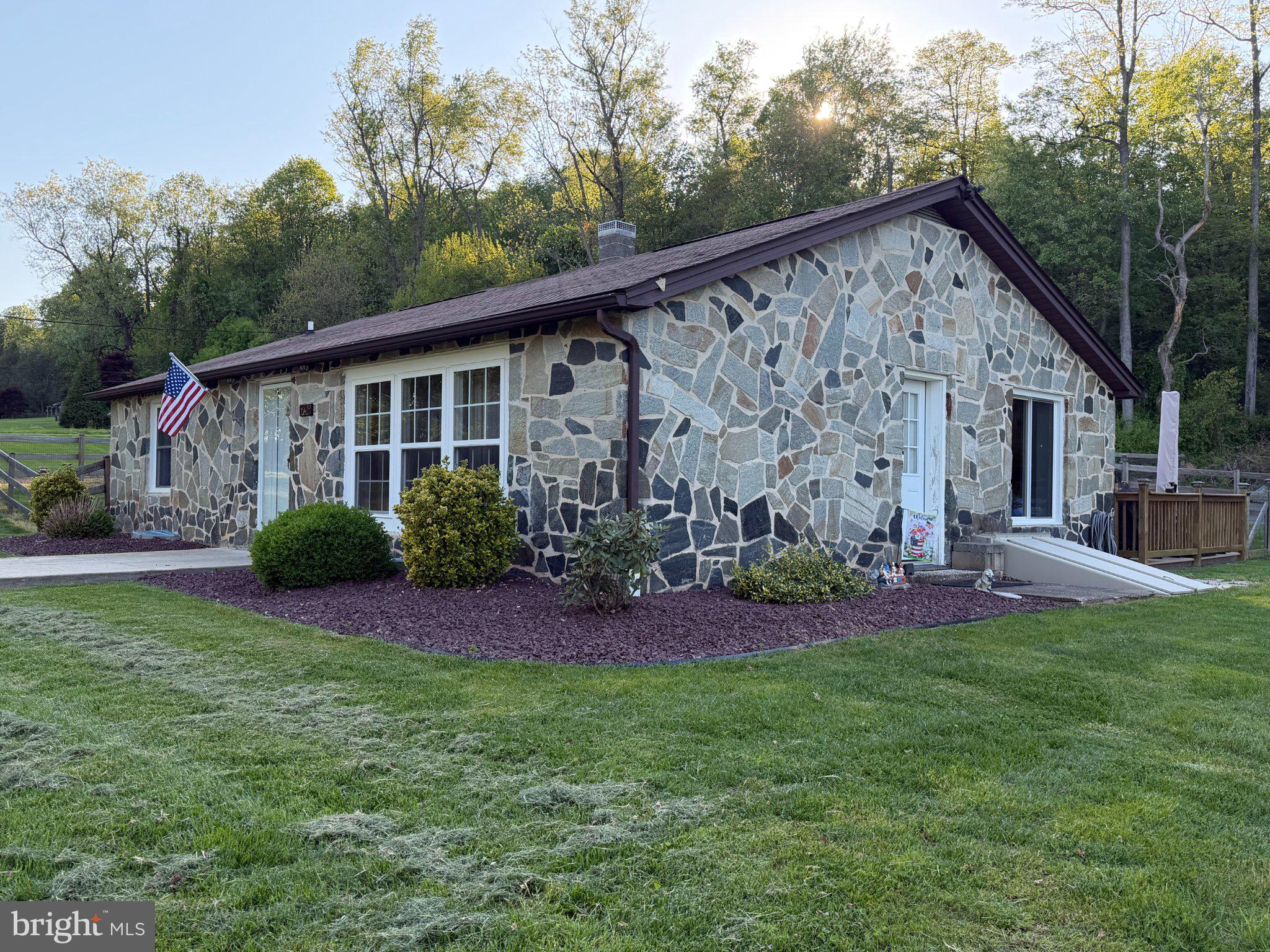 1730 Ridge Road Whiteford, MD 21160 - Photo 2 of 2 Charming stone home with lush greenery.