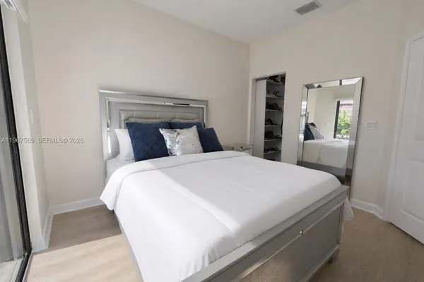 a bedroom with a bed and a large window