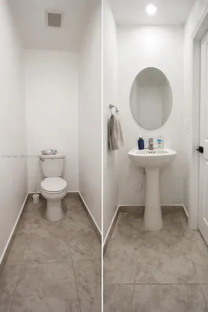 a bathroom with a toilet sink and mirror