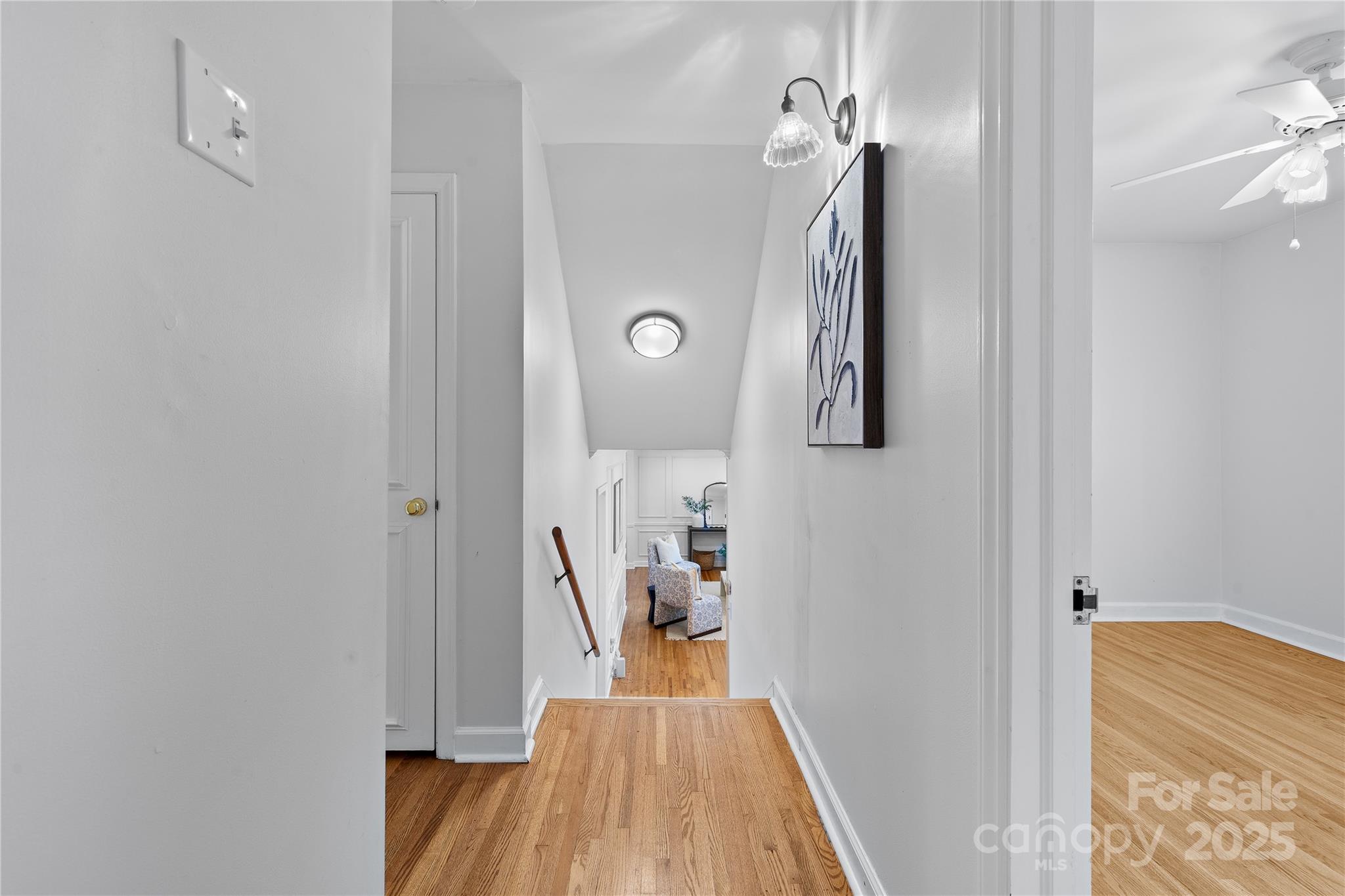 1024 Regency Drive Charlotte, NC 28211 - Photo 28 of 47 a view of a hallway with wooden floor and a livingroom