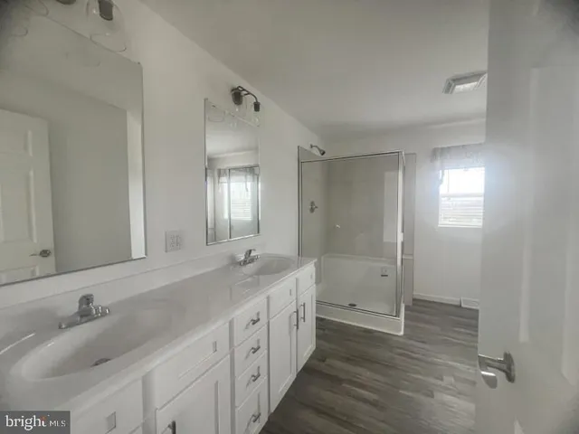 a bathroom with a double vanity sink and a mirror