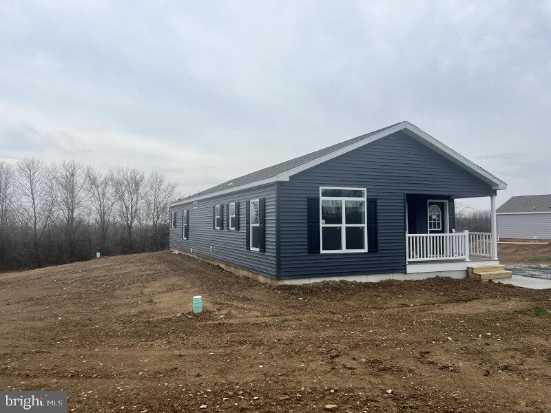 71 Ash Road Hamburg, PA 19526 - Photo 2 of 21 a front view of house with yard and trees in the background