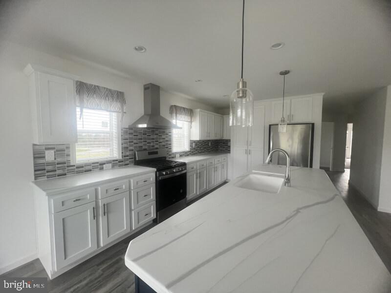 71 Ash Road Hamburg, PA 19526 - Photo 4 of 21 a large kitchen with a stove a sink dishwasher a refrigerator and white cabinets with wooden floor