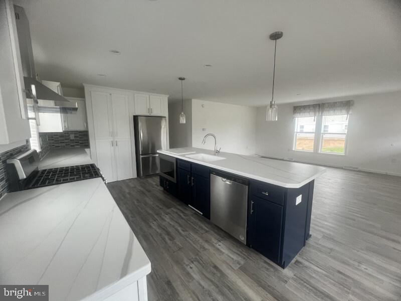 71 Ash Road Hamburg, PA 19526 - Photo 6 of 21 a kitchen with stainless steel appliances granite countertop a sink a stove and a wooden floor