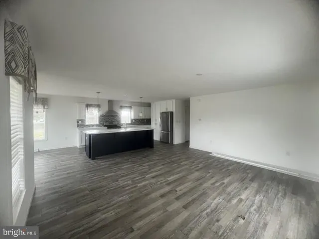a view of kitchen and kitchen with wooden floor