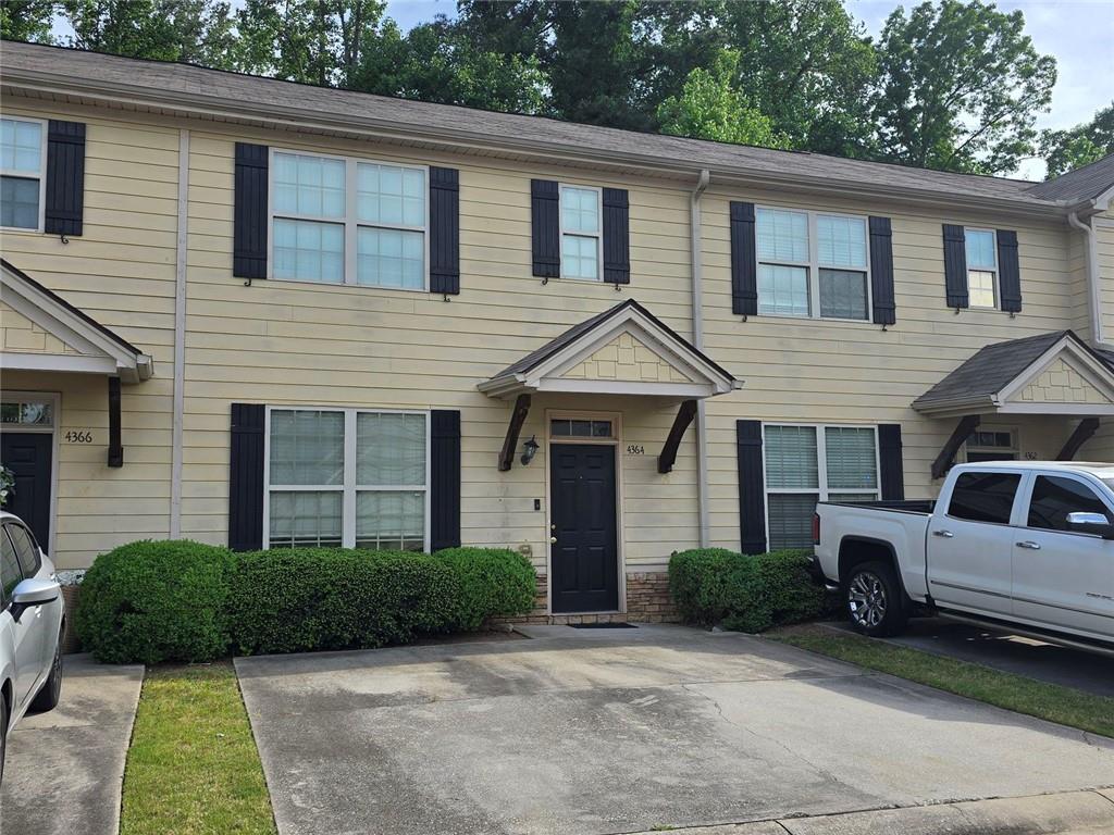 4364 Stone Gate Way, Unit 94 East Point, GA 30344 - Photo 2 of 2 a front view of a house with a yard