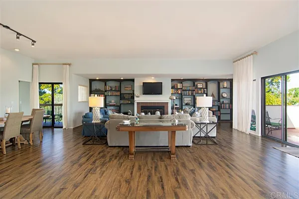 a living room with fireplace furniture and a wooden floor