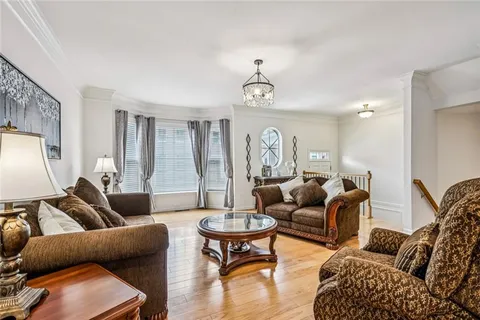 a kitchen island with stainless steel appliances granite countertop sink stove and wooden floor