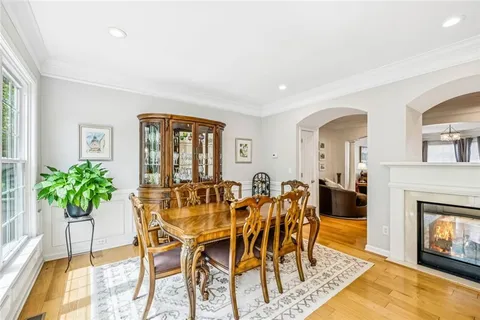 a bathroom with a granite countertop tub a double vanity sink a vanity and a large mirror