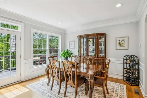 a living room with furniture a flat screen tv and a large window