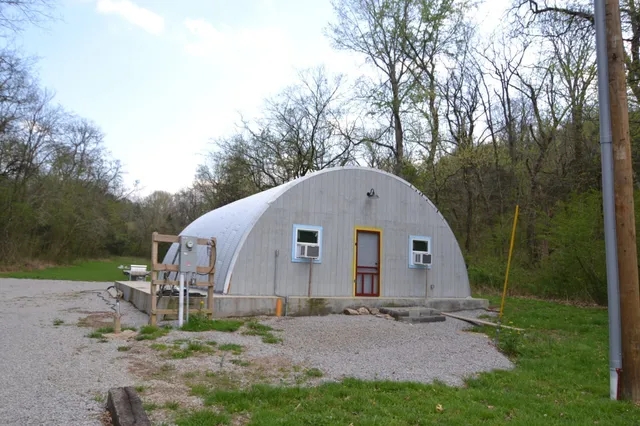 a view of backyard with small cabin