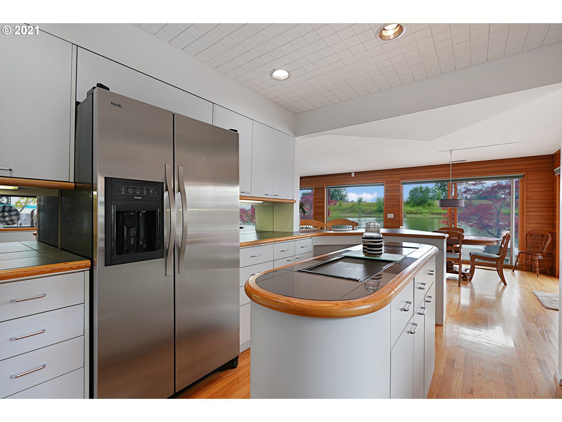 14583 Northwest Larson Road, Unit 6 Portland, OR 97231 - Photo 5 of 32 a kitchen with stainless steel appliances granite countertop a sink a refrigerator and a refrigerator