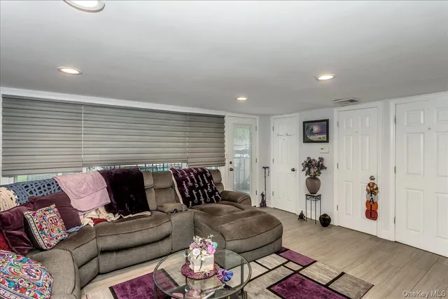 a bedroom with furniture and a wooden floor
