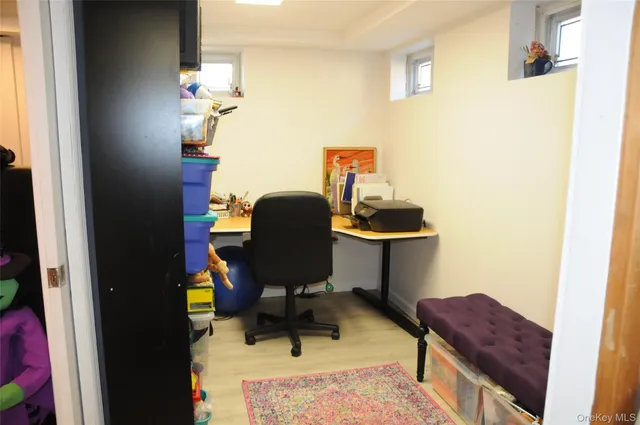 a view of workspace filled with furniture and wooden floor
