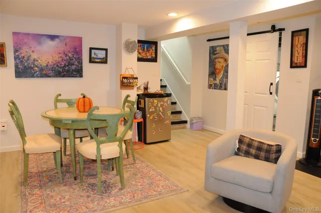 a living room with furniture and kitchen view