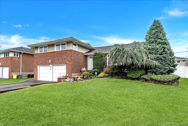 a front view of a house with a yard and garage