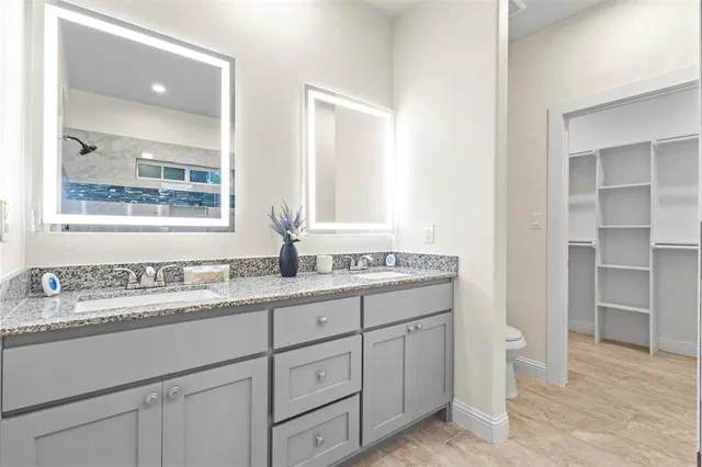 a bathroom with a granite countertop sink a shower and a mirror