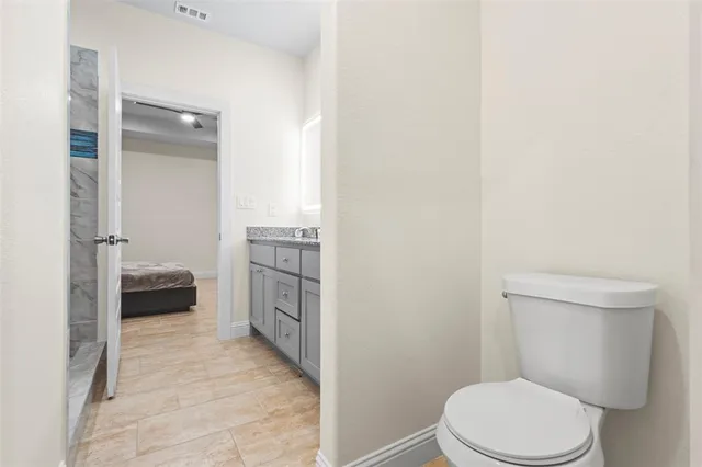 a bathroom with a granite countertop sink a mirror and shower