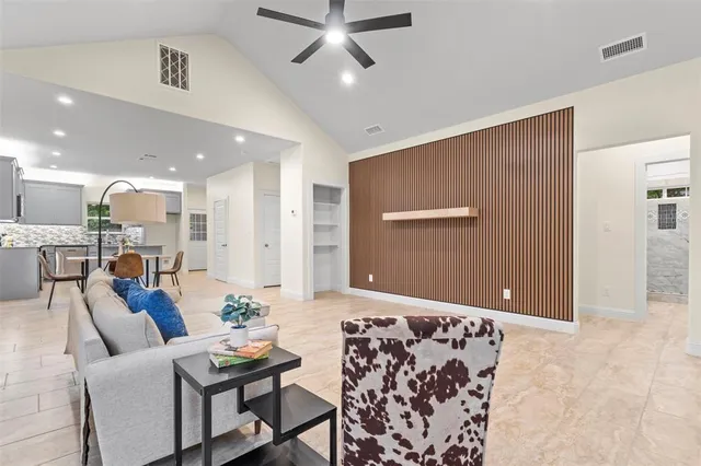 a living room with furniture and kitchen view