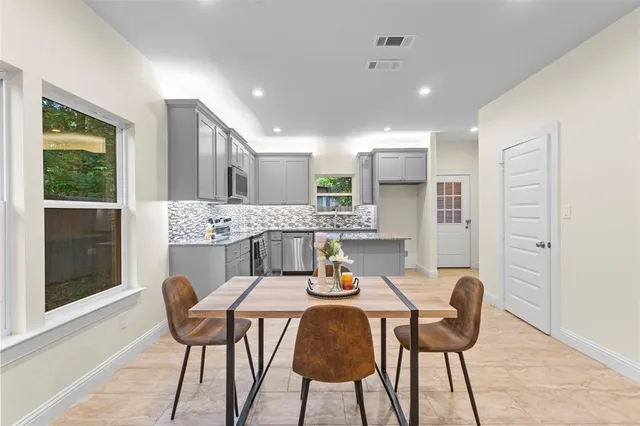 a view of a dining room with furniture and window