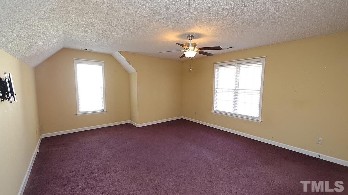 3545 Dewing Drive Raleigh, NC 27616 - Photo 12 of 13 an empty room with windows and chandelier fan
