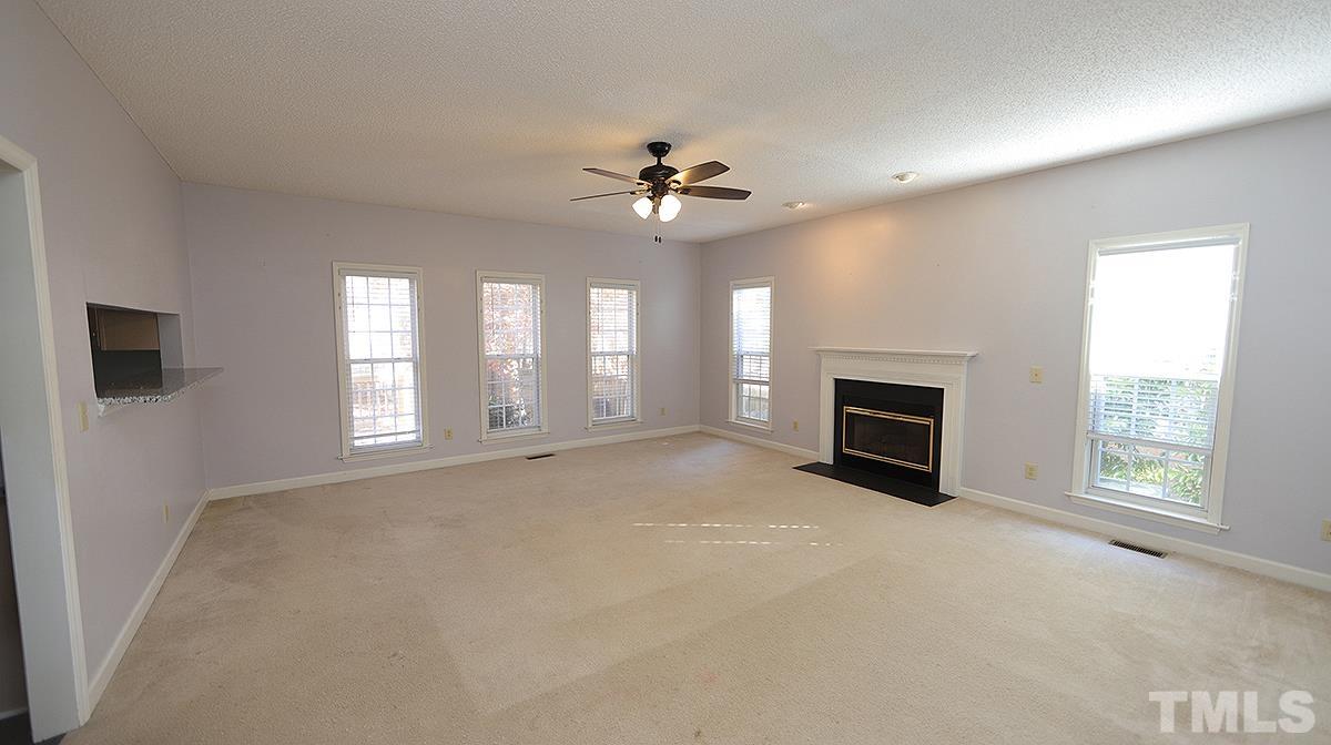 3545 Dewing Drive Raleigh, NC 27616 - Photo 5 of 13 an empty room with windows and fireplace