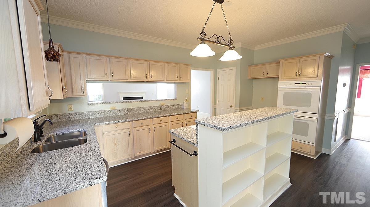 3545 Dewing Drive Raleigh, NC 27616 - Photo 6 of 13 a kitchen with granite countertop a sink cabinets and wooden floor