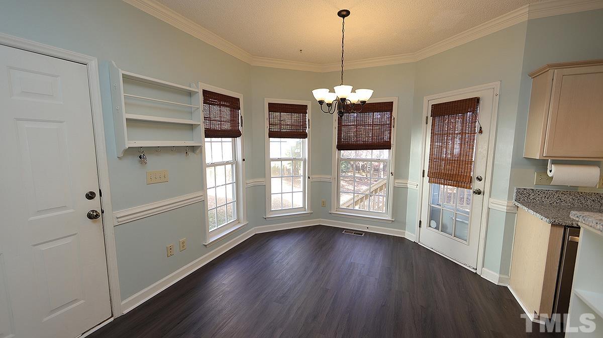 3545 Dewing Drive Raleigh, NC 27616 - Photo 7 of 13 a view of an empty room with window and wooden floor