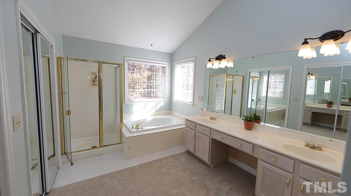 3545 Dewing Drive Raleigh, NC 27616 - Photo 9 of 13 a bathroom with a tub sink shower and mirror
