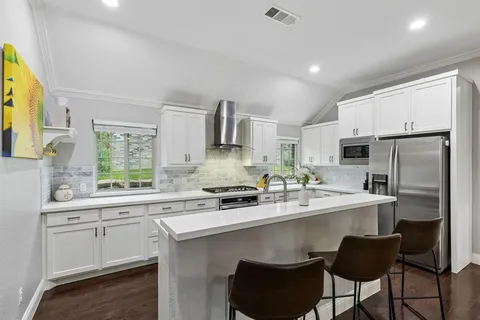 a kitchen with stainless steel appliances a sink stove and refrigerator