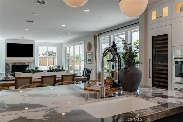a living room with furniture a large window and a flat screen tv